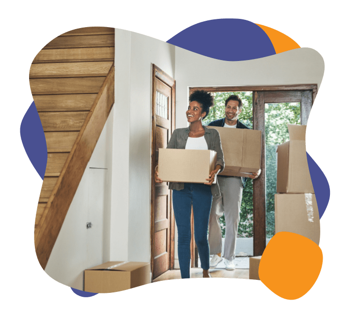 Couple holding boxes moving in to their newly cleaned home from Enviropure's Move in Move Out Cleaning